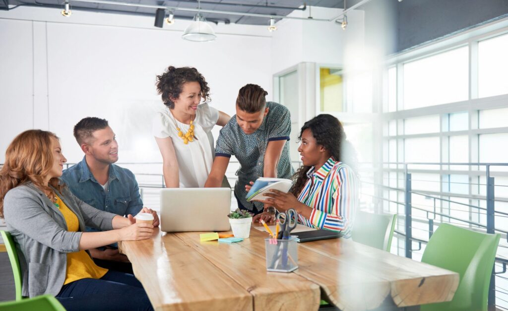 Multi ethnic group of succesful creative business people using a